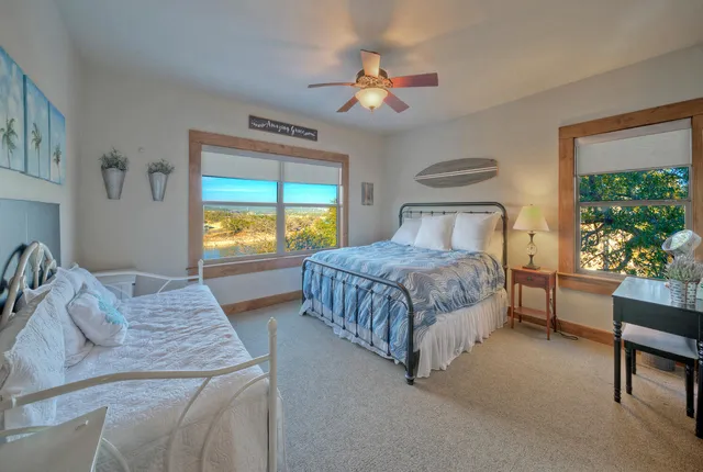 a bedroom with two beds and a window