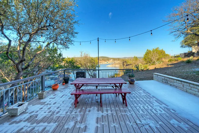a balcony with wooden floor and outdoor seating