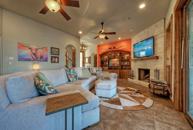 a living room with furniture a fireplace and a flat screen tv
