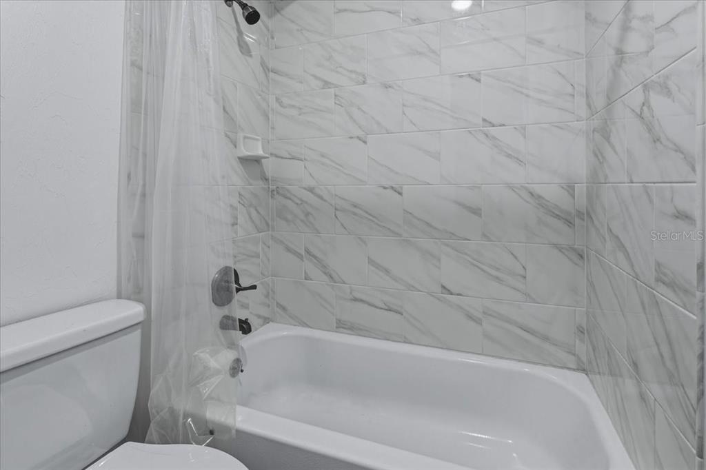 2508 Southwest 35th Place, Unit D19 Gainesville, FL 32608 - Photo 12 of 25 a bathroom with a bathtub and a toilet