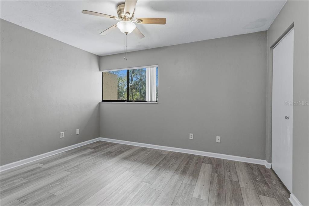 2508 Southwest 35th Place, Unit D19 Gainesville, FL 32608 - Photo 16 of 25 wooden floor in an empty room with a window