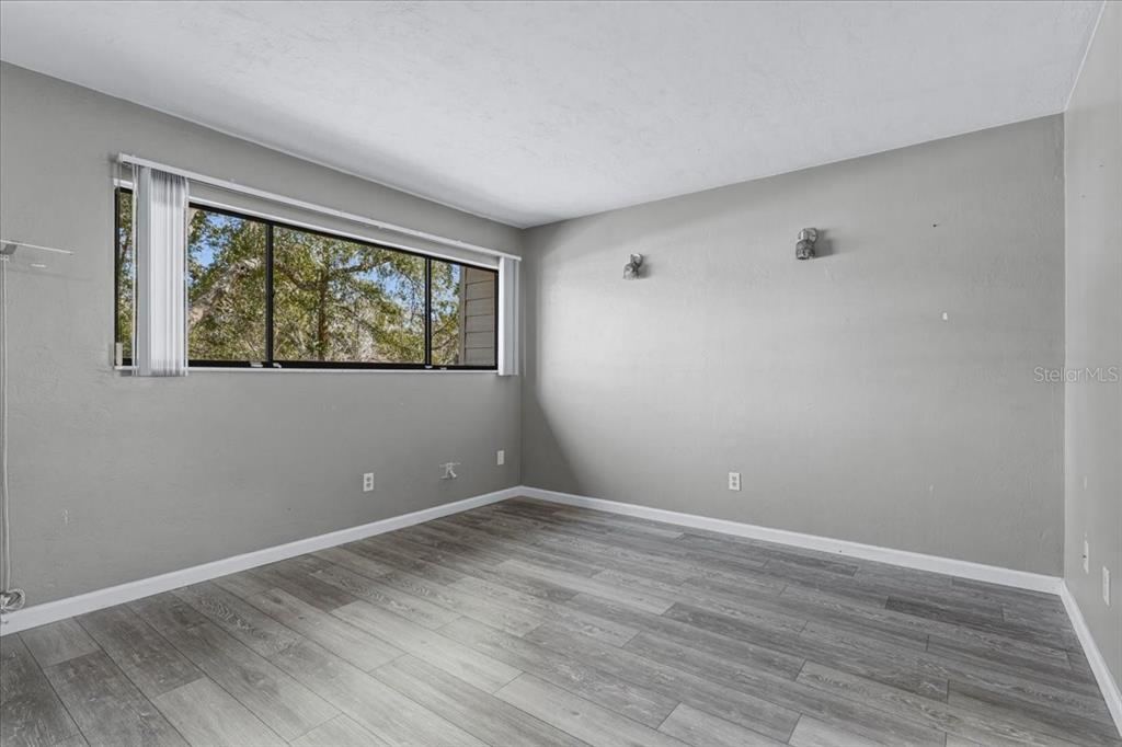 2508 Southwest 35th Place, Unit D19 Gainesville, FL 32608 - Photo 19 of 25 a view of room with hardwood floor and window