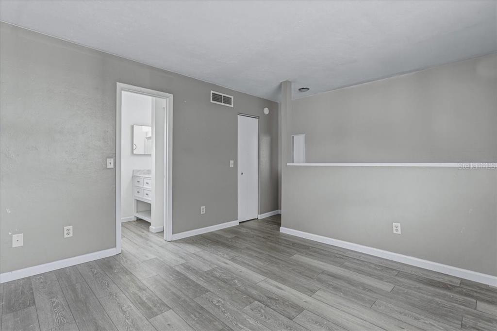 2508 Southwest 35th Place, Unit D19 Gainesville, FL 32608 - Photo 21 of 25 a view of an empty room with wooden floor