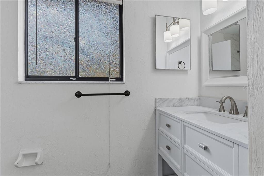 2508 Southwest 35th Place, Unit D19 Gainesville, FL 32608 - Photo 22 of 25 a bathroom with a sink and a mirror