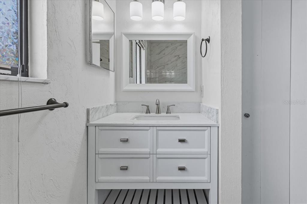 2508 Southwest 35th Place, Unit D19 Gainesville, FL 32608 - Photo 24 of 25 a bathroom with a shower a sink and a mirror