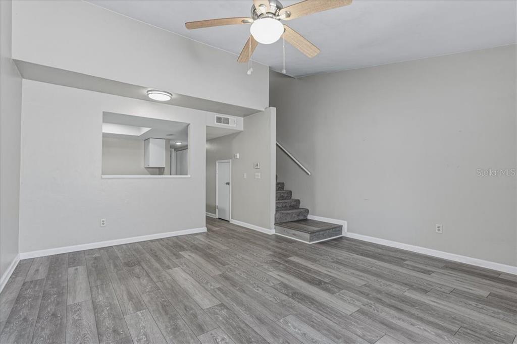 2508 Southwest 35th Place, Unit D19 Gainesville, FL 32608 - Photo 5 of 25 wooden floor in an empty room with a window