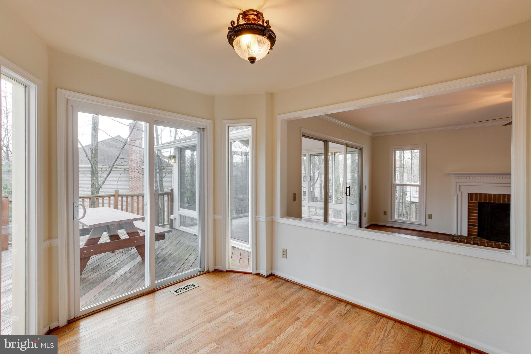 8402 Shadeland Road Laurel, MD 20724 - Photo 14 of 30 a view of an empty room with a fireplace and a window