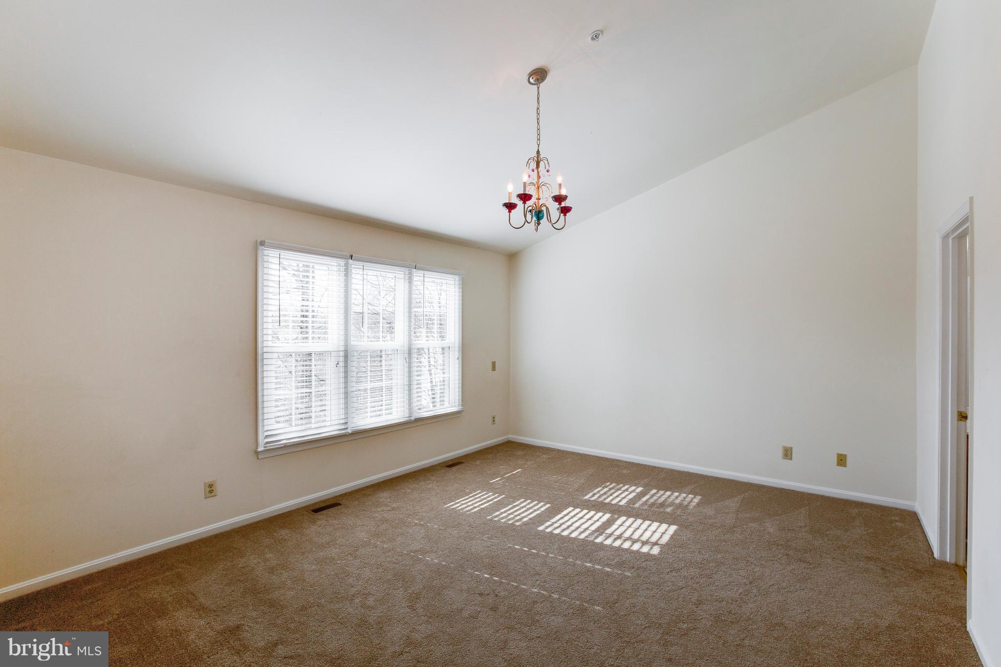 8402 Shadeland Road Laurel, MD 20724 - Photo 15 of 30 an empty room with chandelier fan and windows