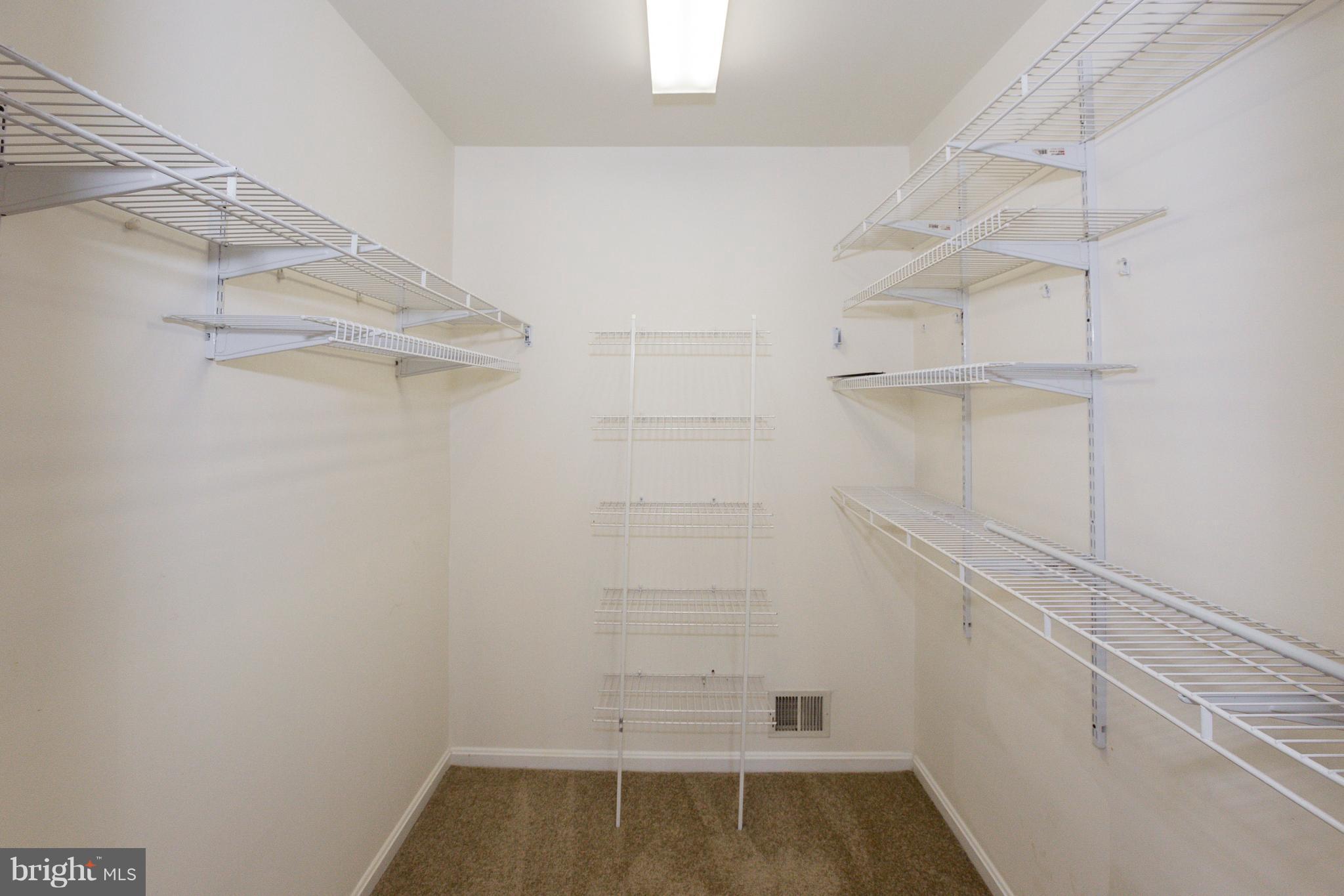 8402 Shadeland Road Laurel, MD 20724 - Photo 18 of 30 a view of walk in closet with empty racks