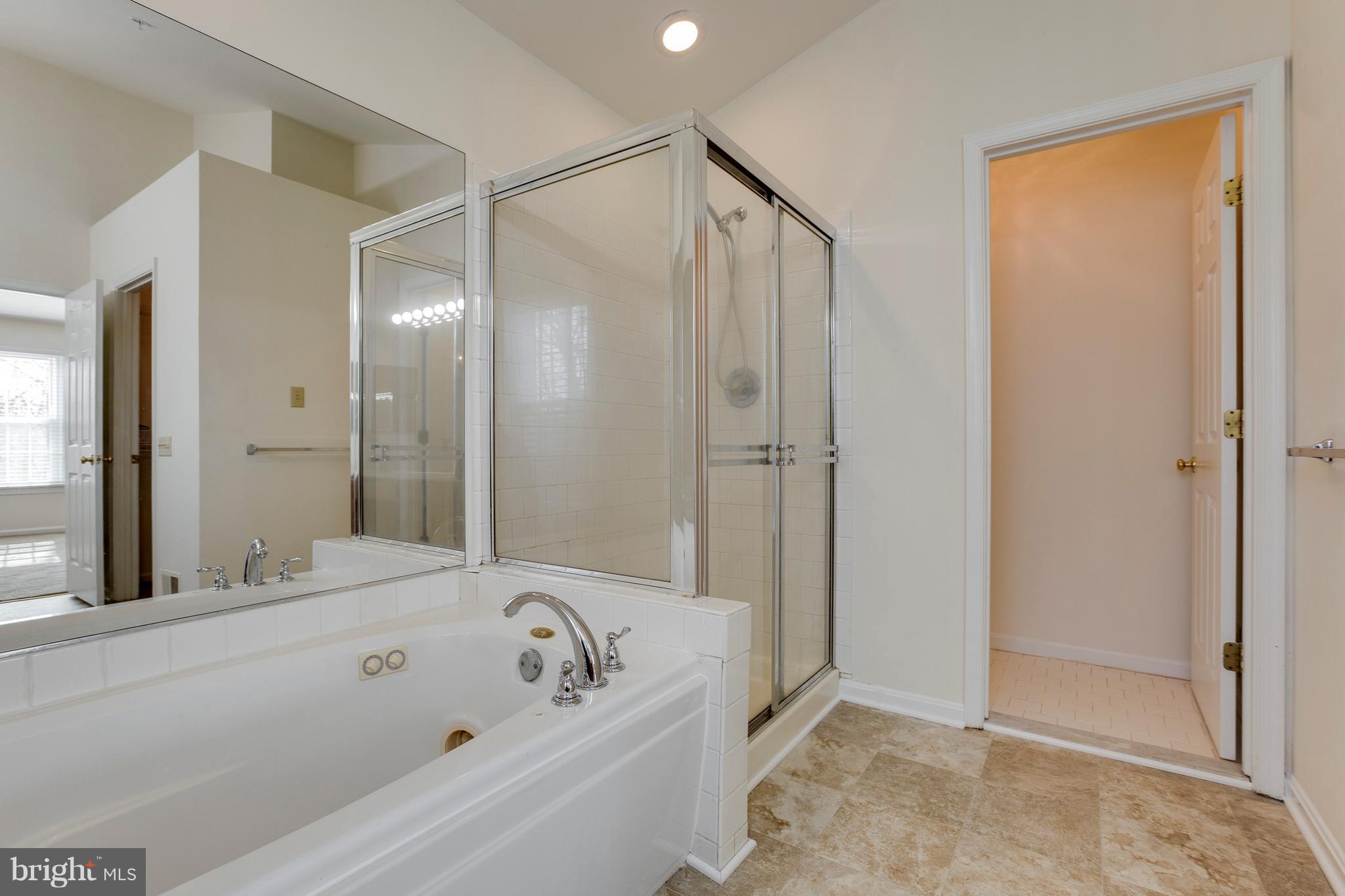 8402 Shadeland Road Laurel, MD 20724 - Photo 20 of 30 a bathroom with a bathtub and a shower