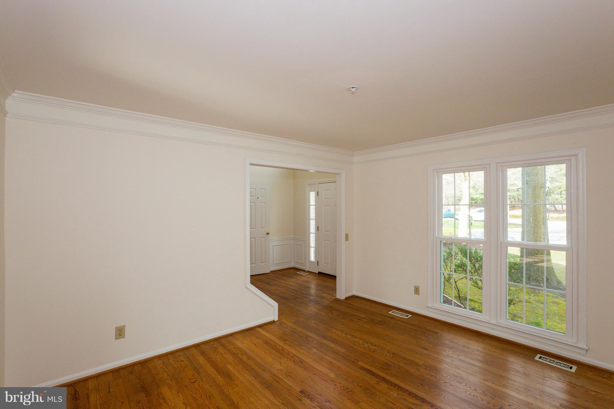8402 Shadeland Road Laurel, MD 20724 - Photo 3 of 30 a view of an empty room with wooden floor and a window