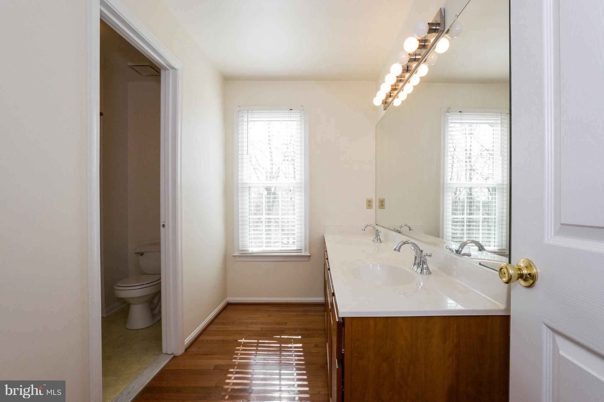 8402 Shadeland Road Laurel, MD 20724 - Photo 22 of 30 a bathroom with a sink a shower and a mirror