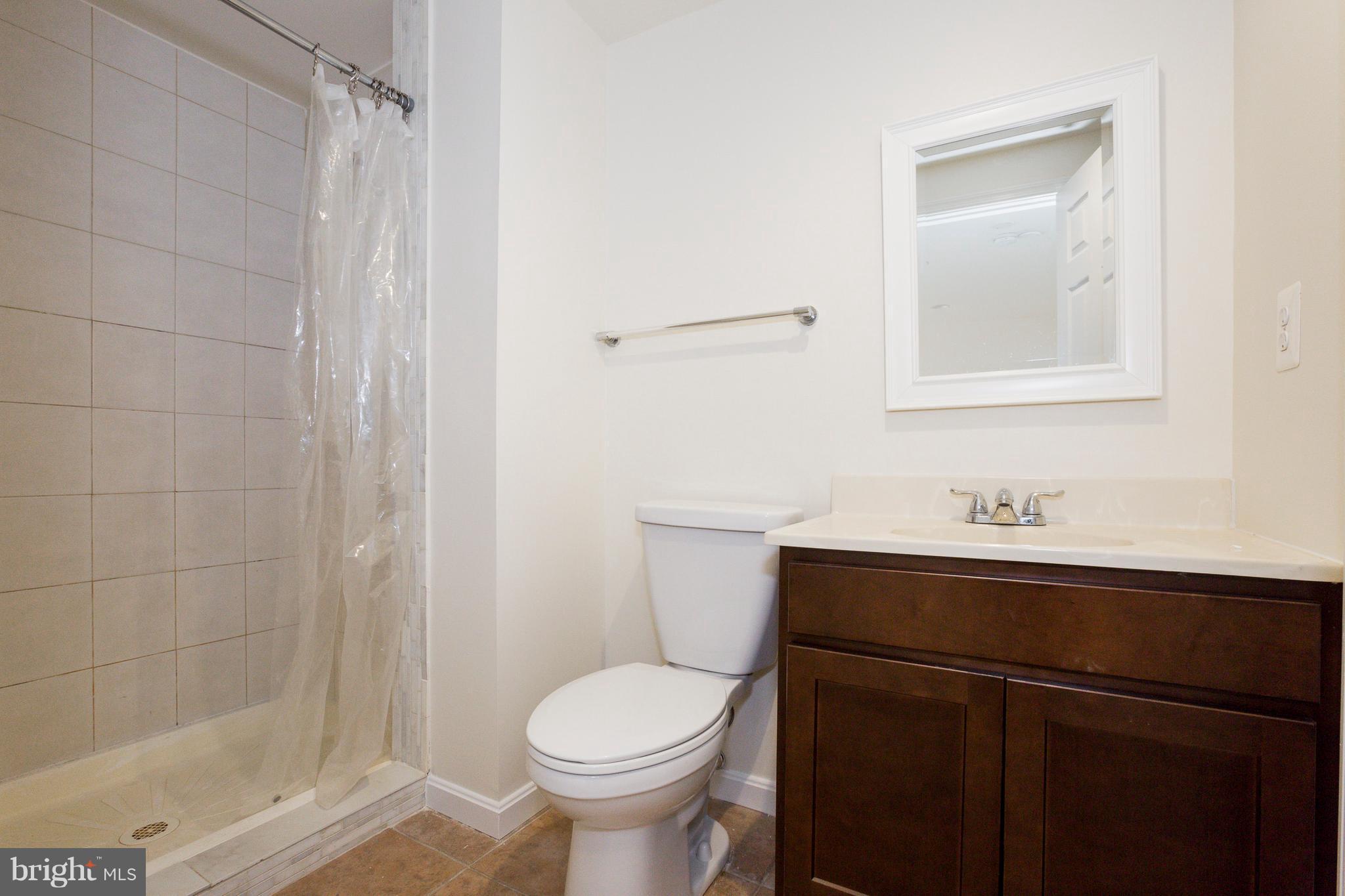 8402 Shadeland Road Laurel, MD 20724 - Photo 28 of 30 a bathroom with a sink a toilet and shower