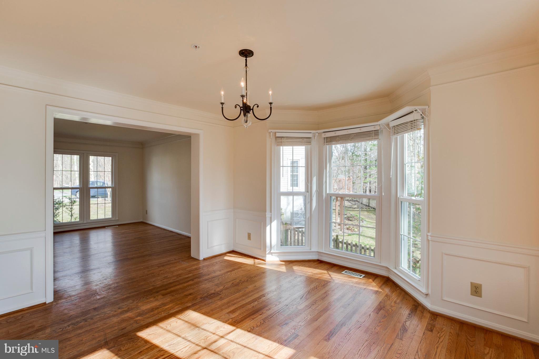 8402 Shadeland Road Laurel, MD 20724 - Photo 4 of 30 a view of an empty room with wooden floor and a window