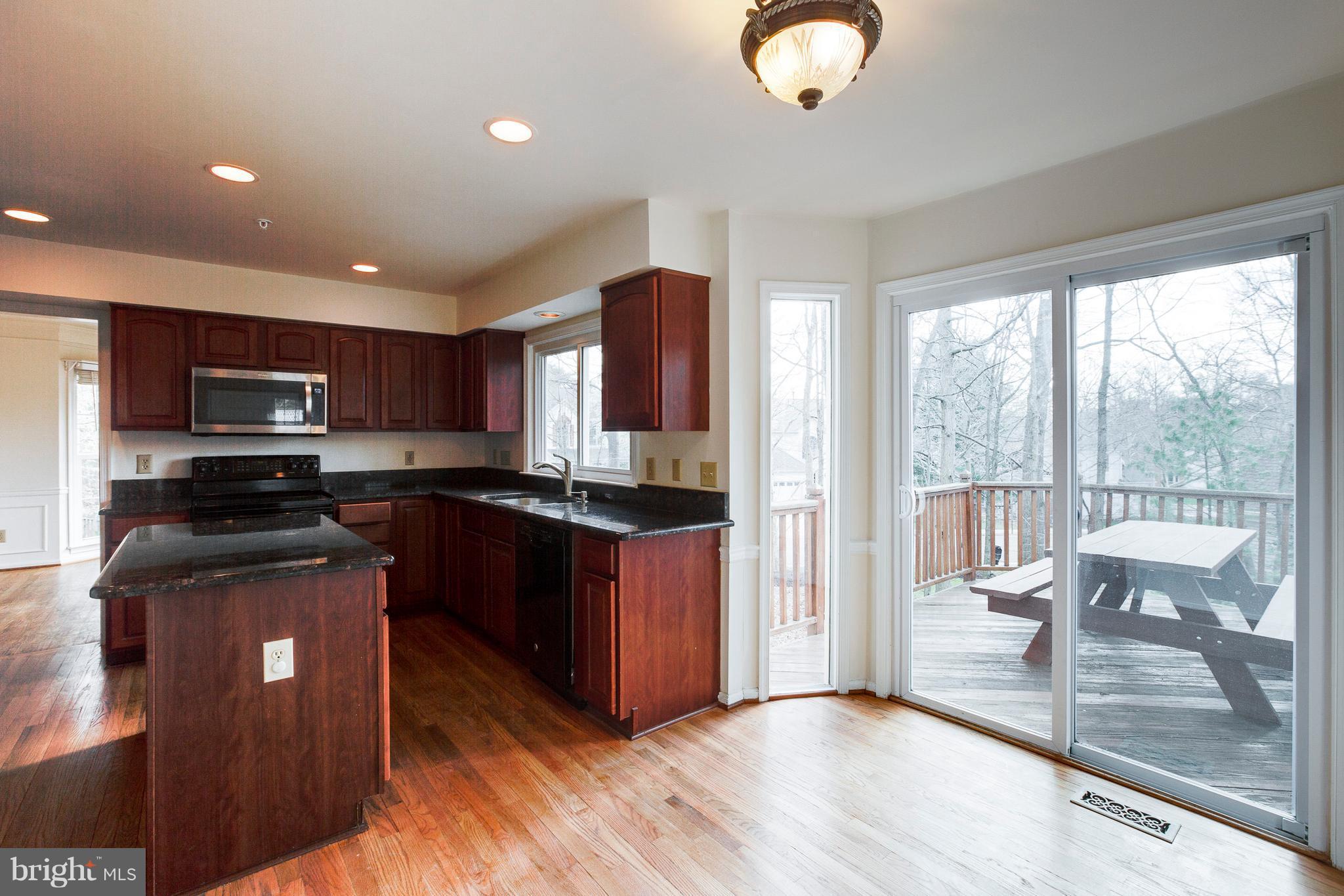 8402 Shadeland Road Laurel, MD 20724 - Photo 7 of 30 a kitchen with stainless steel appliances granite countertop a refrigerator stove top oven and sink