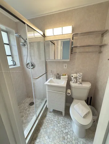 a bathroom with a toilet sink and a shower