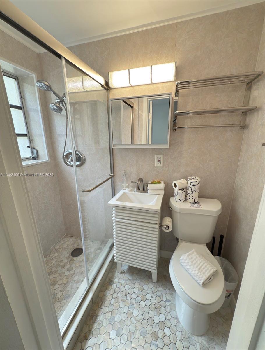 545 Michigan Avenue, Unit 1 Miami Beach, FL 33139 - Photo 12 of 12 a bathroom with a toilet sink and a shower
