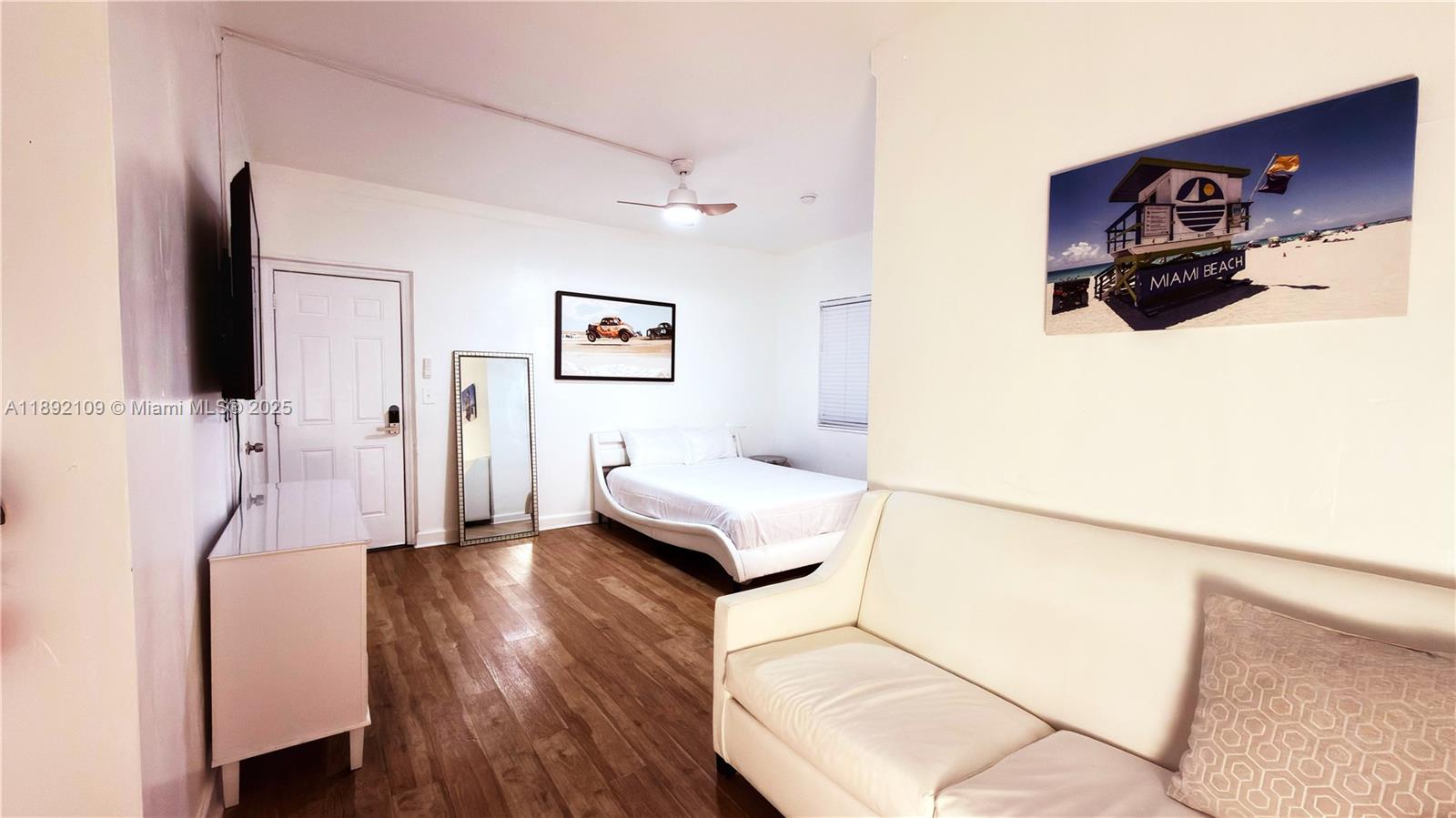 545 Michigan Avenue, Unit 1 Miami Beach, FL 33139 - Photo 3 of 12 a living room with furniture and a flat screen tv