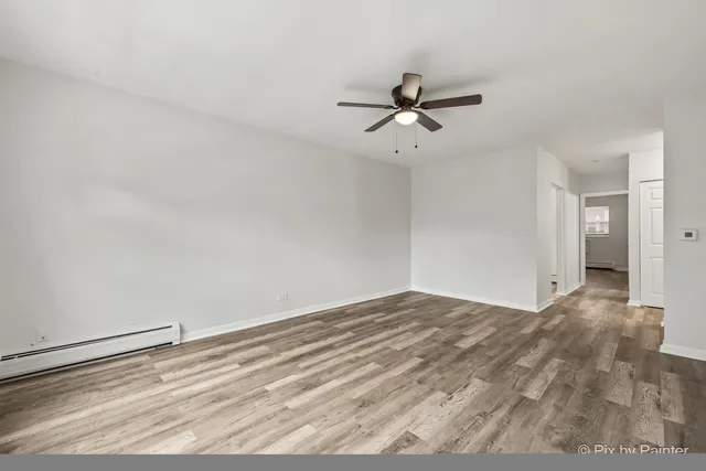 a view of empty room with ceiling fan