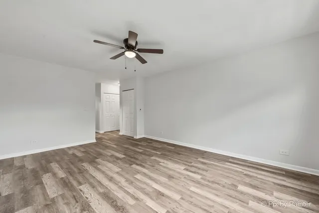 a view of empty room with ceiling fan
