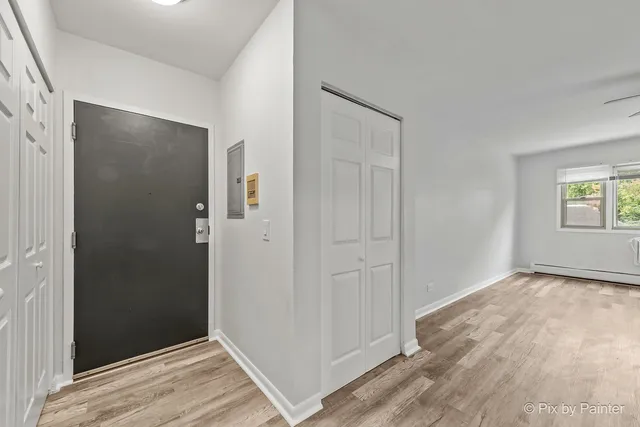 an empty room with windows and closet