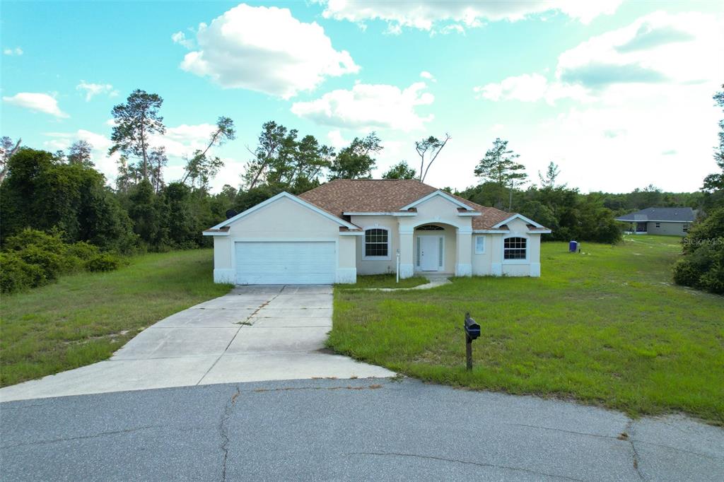 3858 Southwest 161st Street Ocala, FL 34473 - Photo 2 of 67 a front view of a house with a yard and garage
