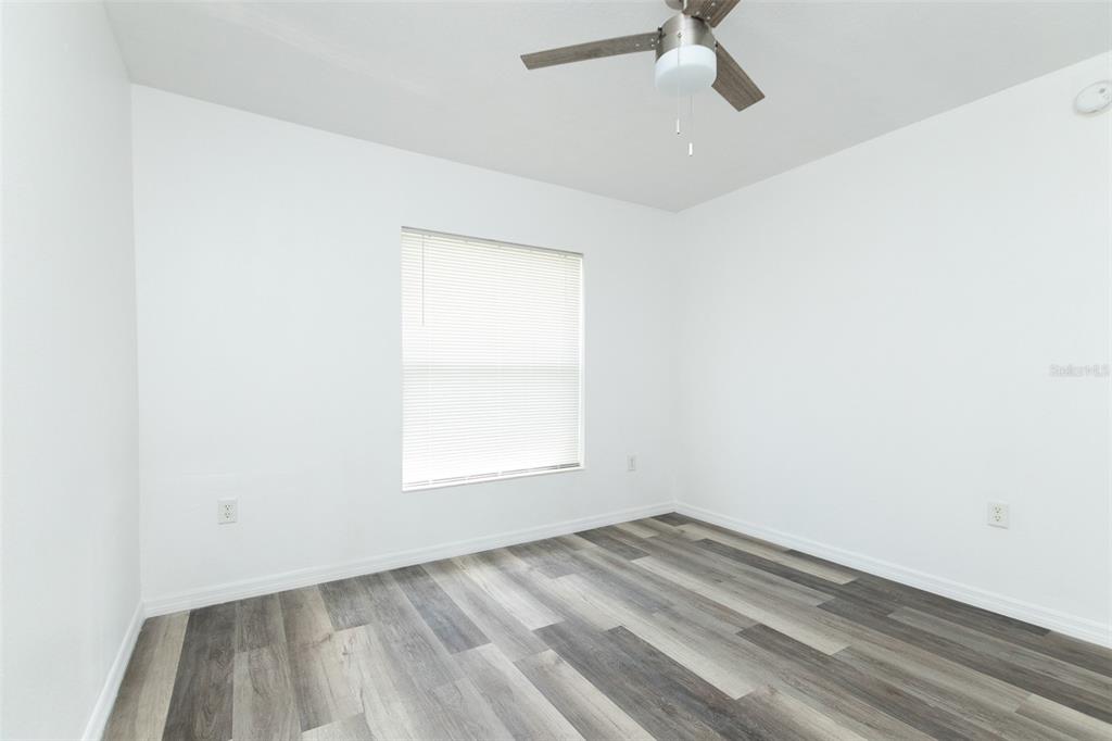 3858 Southwest 161st Street Ocala, FL 34473 - Photo 25 of 67 an empty room with a window and ceiling fan