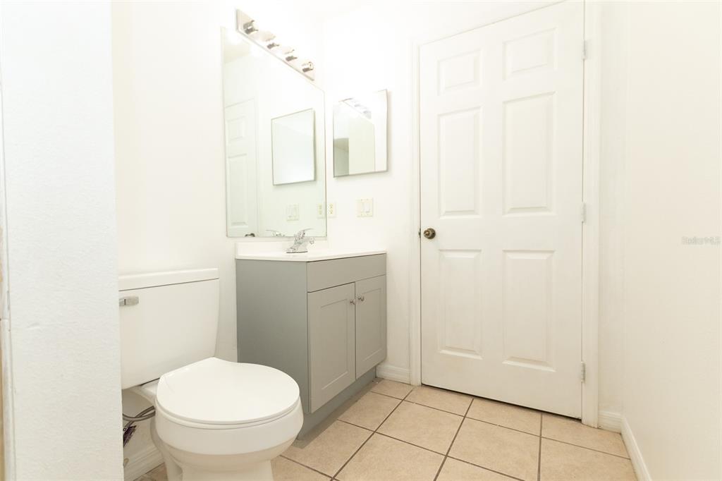 3858 Southwest 161st Street Ocala, FL 34473 - Photo 29 of 67 a bathroom with a toilet a sink and mirror