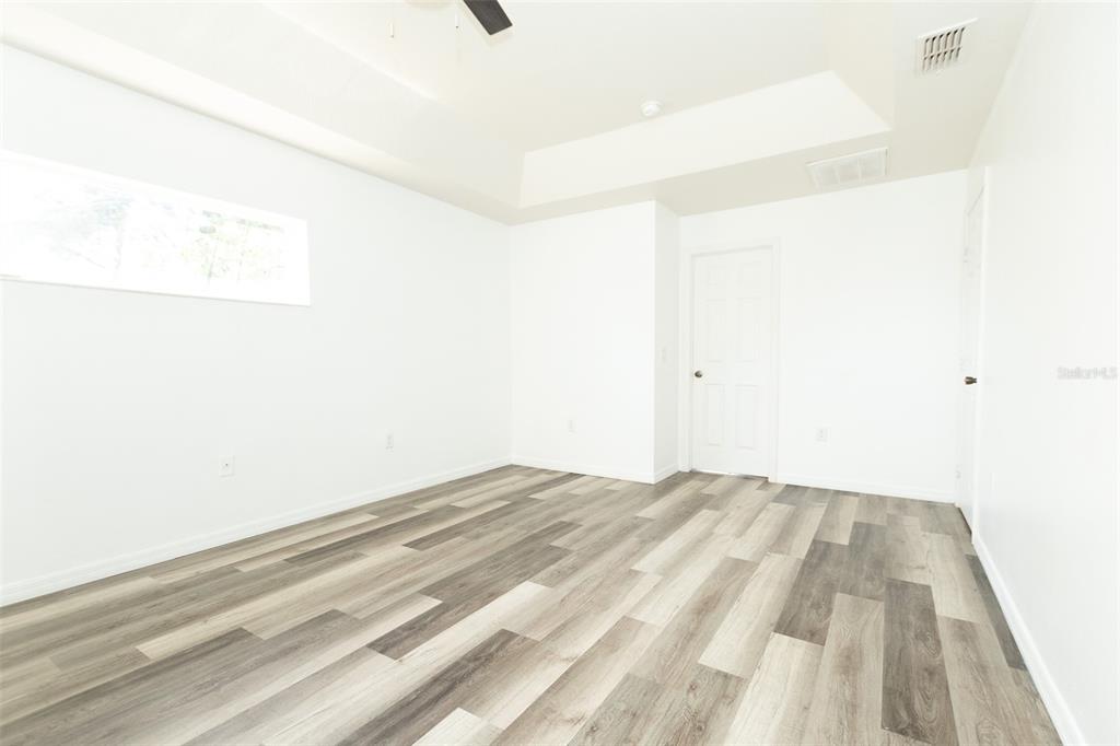 3858 Southwest 161st Street Ocala, FL 34473 - Photo 35 of 67 a bedroom with a bed and a white wall