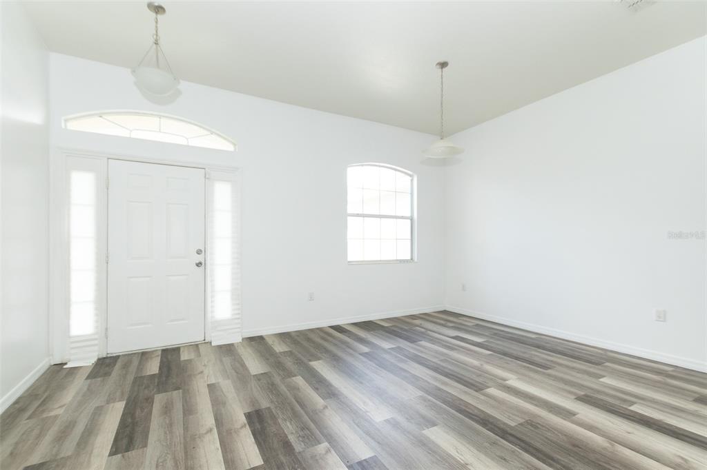 3858 Southwest 161st Street Ocala, FL 34473 - Photo 4 of 67 a view of empty room with wooden floor and fan