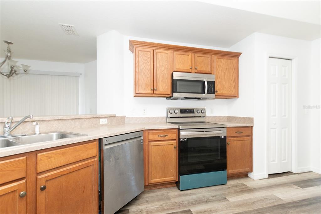 3858 Southwest 161st Street Ocala, FL 34473 - Photo 51 of 67 a kitchen with stainless steel appliances granite countertop a stove microwave and sink