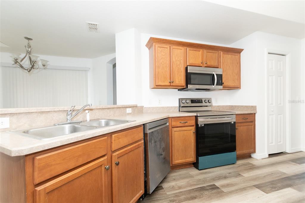 3858 Southwest 161st Street Ocala, FL 34473 - Photo 57 of 67 a kitchen with granite countertop a sink and steel appliances