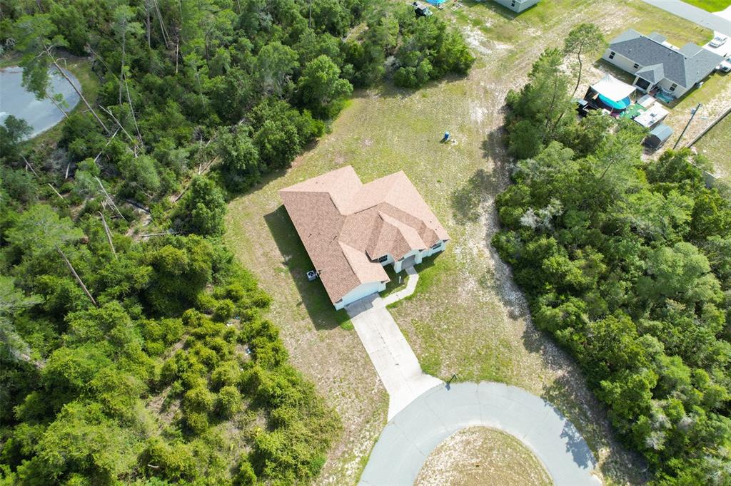 3858 Southwest 161st Street Ocala, FL 34473 - Photo 64 of 67 an aerial view of a house with swimming pool and garden view