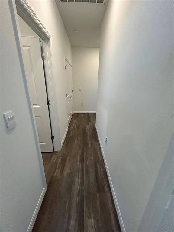 32746 Rustic Rise Road San Antonio, FL 33576 - Photo 14 of 24 a view of a hallway with wooden floor and staircase