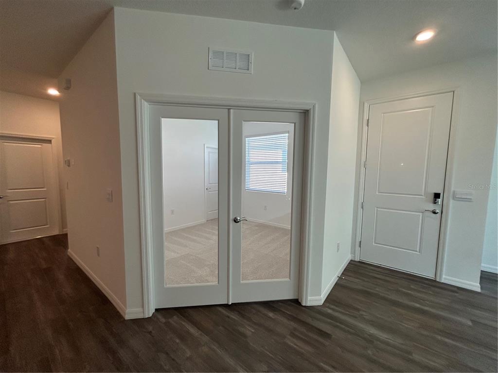 32746 Rustic Rise Road San Antonio, FL 33576 - Photo 15 of 24 an empty room with wooden floor & closet area
