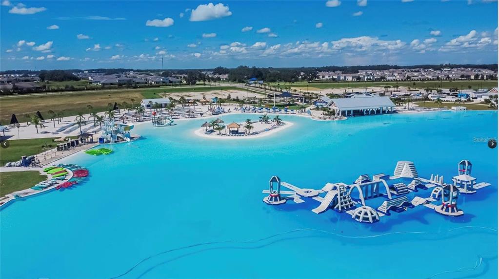 32746 Rustic Rise Road San Antonio, FL 33576 - Photo 2 of 24 a view of a lake with a table and chairs