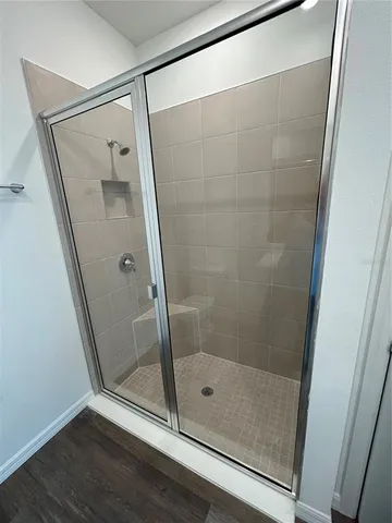 a bathroom with a glass door shower