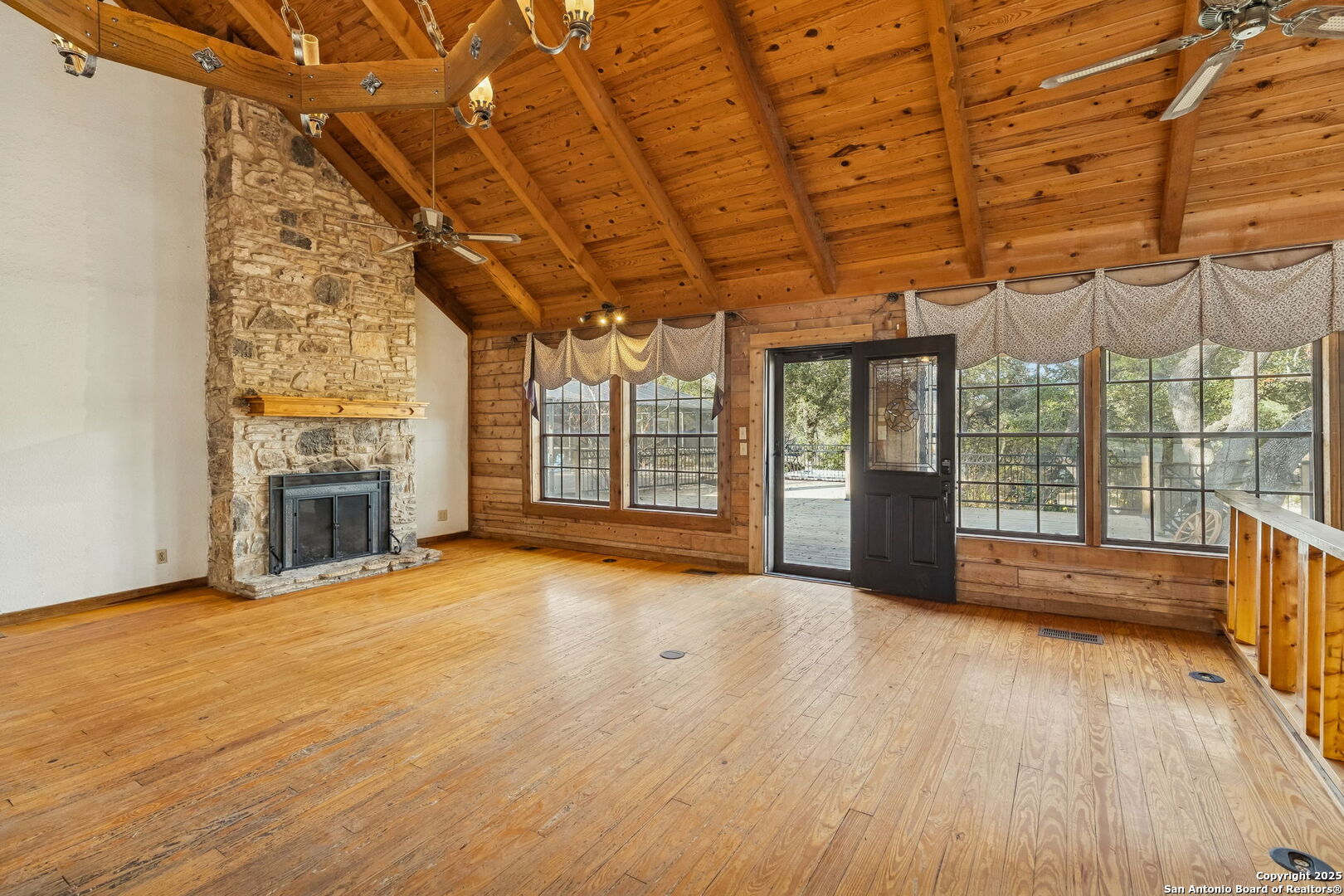 430 Stoney Ridge Bulverde, TX 78163 - Photo 17 of 94 a view of an empty room with a fireplace and wooden floor