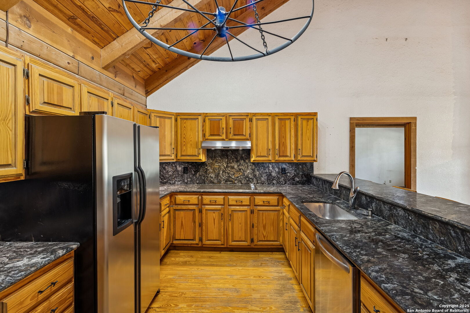 430 Stoney Ridge Bulverde, TX 78163 - Photo 25 of 94 a kitchen with stainless steel appliances granite countertop a sink a stove and a refrigerator