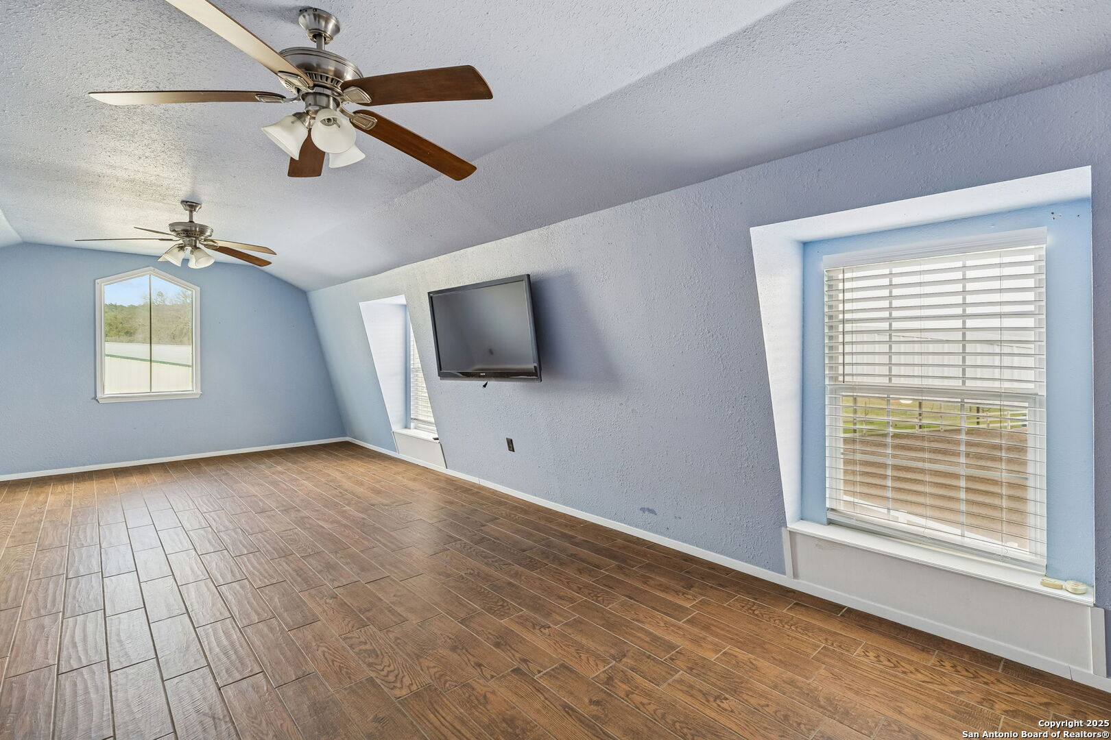 430 Stoney Ridge Bulverde, TX 78163 - Photo 55 of 94 a view of livingroom with hardwood floor and ceiling fan