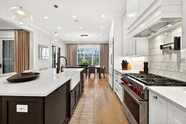 a kitchen with stainless steel appliances a sink stove and cabinets