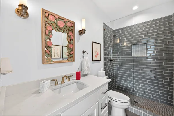 a bathroom with a toilet a sink and a shower