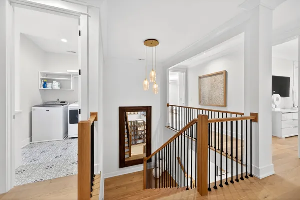 a view of a hallway with entryway wooden floor and front door