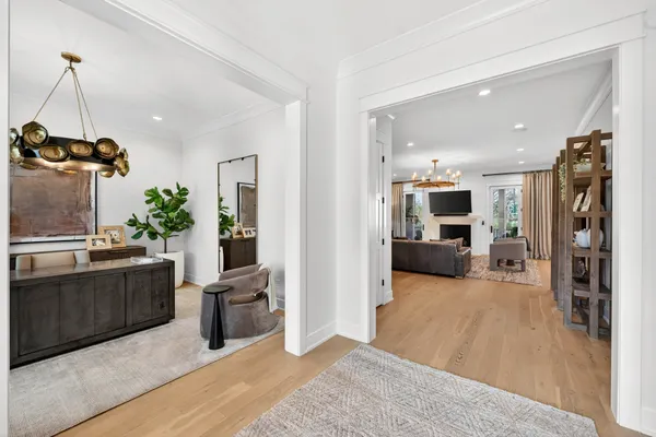 a view of a living room kitchen and a wooden floor
