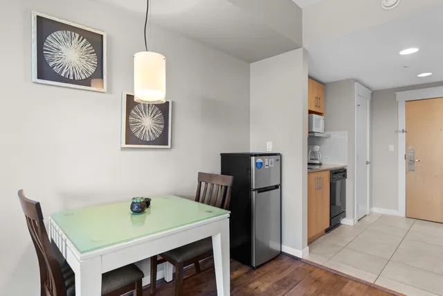 a view of a dining room with furniture and a chandelier