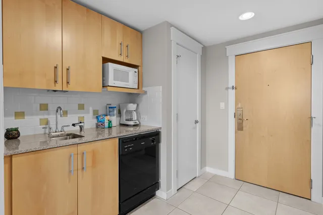 a kitchen with stainless steel appliances granite countertop a refrigerator sink and cabinets