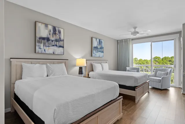 a bedroom with a bed and a large window