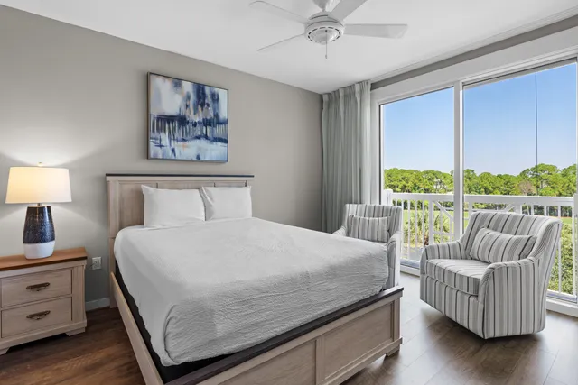 a bedroom with furniture and a large window
