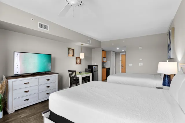 a bedroom with a bed and a flat screen tv