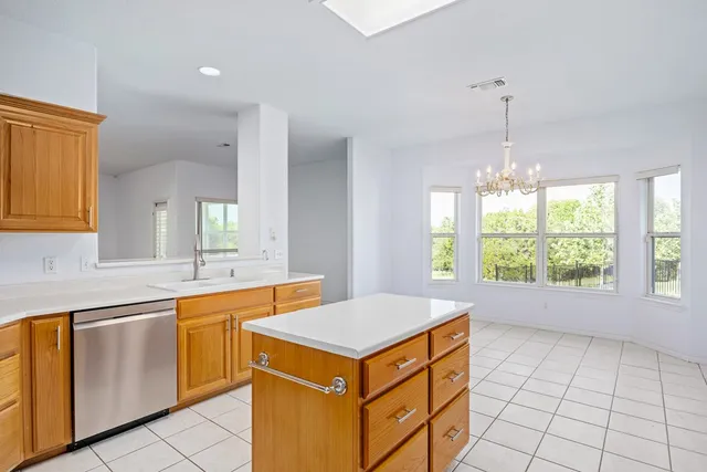 a kitchen that has a sink and a stove in it
